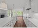 Modern white kitchen featuring white cabinets and marble countertops and stainless steel appliances at 125 Summerlin Dr, Clayton, NC 27527