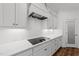 Modern kitchen with white cabinets, marble countertops, and stainless steel appliances at 125 Summerlin Dr, Clayton, NC 27527