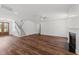Spacious living room featuring hardwood floors, stairs, and a cozy fireplace at 125 Summerlin Dr, Clayton, NC 27527