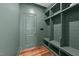 Mudroom with custom shelving features a practical design, door and wood look flooring at 125 Summerlin Dr, Clayton, NC 27527