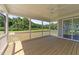 Covered porch with wood flooring, white railing, and screen provides an airy spot to relax at 125 Summerlin Dr, Clayton, NC 27527