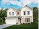 Charming two-story home with a two-car garage, lush green lawn and beautiful landscaping at 128 N Keatts Winner Ct, Clayton, NC 27520