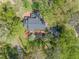 Aerial view of a beautiful home surrounded by lush trees, manicured landscaping, and a paved driveway at 1302 Hermitage Rd, Sanford, NC 27330
