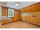 Attic space with wood paneling, window, and overhead lighting at 1302 Hermitage Rd, Sanford, NC 27330