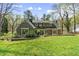 Well-maintained backyard featuring a lush lawn and brick accents, framed by mature landscaping at 1302 Hermitage Rd, Sanford, NC 27330
