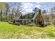 Expansive backyard featuring a well-maintained lawn, brick accents, and mature landscaping at 1302 Hermitage Rd, Sanford, NC 27330