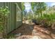 Beautifully landscaped backyard featuring a stone pathway and mature trees for serene outdoor living at 1302 Hermitage Rd, Sanford, NC 27330