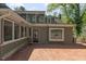 Inviting backyard featuring a screened-in porch and a spacious brick patio perfect for outdoor entertaining at 1302 Hermitage Rd, Sanford, NC 27330