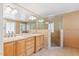 Well-lit bathroom features a double vanity and a tiled glass-enclosed shower at 1302 Hermitage Rd, Sanford, NC 27330