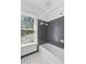 Bathroom with black and white tiled floor and tub at 1302 Hermitage Rd, Sanford, NC 27330