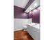Bathroom with hardwood floors, wainscoting, and a white vanity at 1302 Hermitage Rd, Sanford, NC 27330