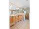 Well-lit bathroom features a double vanity and a tiled glass-enclosed shower at 1302 Hermitage Rd, Sanford, NC 27330