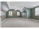 Spacious bedroom with green walls, carpeted floor and two windows at 1302 Hermitage Rd, Sanford, NC 27330