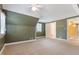Large bedroom with green accent walls, carpet, ceiling fan and white trim at 1302 Hermitage Rd, Sanford, NC 27330
