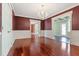 Formal dining room with hardwood floors, crown molding and access to the sunroom at 1302 Hermitage Rd, Sanford, NC 27330