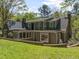 Home exterior with yard, mature trees, and landscaping providing a lush background at 1302 Hermitage Rd, Sanford, NC 27330
