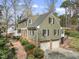 View of side and back of home showing multi-car garage and brick and siding construction at 1302 Hermitage Rd, Sanford, NC 27330