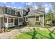 The exterior of this lovely home features a quaint porch and manicured landscaping at 1302 Hermitage Rd, Sanford, NC 27330