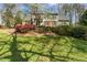 Well-maintained two-story home on a sprawling lot with a charming mix of trees and landscaping at 1302 Hermitage Rd, Sanford, NC 27330