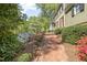 Landscaped walkway with flowering shrubs leading to the front door of a well maintained house at 1302 Hermitage Rd, Sanford, NC 27330
