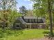 Exterior home showcasing the well-manicured lawn and mature trees in a lush landscape at 1302 Hermitage Rd, Sanford, NC 27330