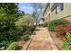Charming front walkway with manicured landscaping leading to the front entrance of this classic home at 1302 Hermitage Rd, Sanford, NC 27330