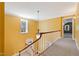 Hallway with wood railing on staircase and hanging light fixture at 1302 Hermitage Rd, Sanford, NC 27330
