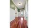 Hallway with hardwood floors and white wainscoting features a door to the backyard at 1302 Hermitage Rd, Sanford, NC 27330