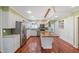 Bright kitchen with stainless steel appliances, island with butcher block top, and hardwood floors at 1302 Hermitage Rd, Sanford, NC 27330