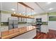 Modern kitchen features a central island with wood top, stainless appliances, and plenty of cabinet space at 1302 Hermitage Rd, Sanford, NC 27330