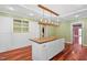 Bright eat-in kitchen with custom island, hardwood floors and modern lighting at 1302 Hermitage Rd, Sanford, NC 27330