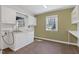 Laundry room with storage cabinets, sink, countertop space, and a window for natural light at 1302 Hermitage Rd, Sanford, NC 27330