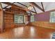 Living room with hardwood floors, wood paneling, vaulted ceiling and built-in bookcase at 1302 Hermitage Rd, Sanford, NC 27330