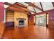 Living room features a brick fireplace, hardwood floors, and wood paneling at 1302 Hermitage Rd, Sanford, NC 27330