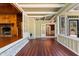 Open sunroom with hardwood floors, brick accent and transitions to an open living space at 1302 Hermitage Rd, Sanford, NC 27330