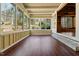Bright sunroom featuring hardwood floors, large windows, and views of the backyard at 1302 Hermitage Rd, Sanford, NC 27330