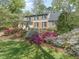 Beautifully landscaped yard with a variety of colorful azaleas and flowering trees surrounding a well-maintained lawn at 1302 Hermitage Rd, Sanford, NC 27330