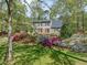Lush front yard featuring colorful azaleas and flowering trees surrounding a well-maintained lawn at 1302 Hermitage Rd, Sanford, NC 27330