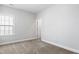 Bedroom featuring neutral walls, carpet, a window with blinds and white trim and door at 139 Pronghorn Deer Ct, Garner, NC 27529
