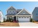 Charming two-story home with gray siding, white trim, a two-car garage, and a well-manicured front lawn at 139 Pronghorn Deer Ct, Garner, NC 27529