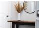 Stylish hallway decor featuring a wooden table, modern mirror, decorative vase, and neutral wall paint at 139 Pronghorn Deer Ct, Garner, NC 27529