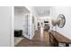 Bright hallway featuring hardwood floors, stylish decor, and an open view into the living room and kitchen at 139 Pronghorn Deer Ct, Garner, NC 27529