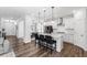 Kitchen island with black bar stools and open concept to living room and dining area at 139 Pronghorn Deer Ct, Garner, NC 27529