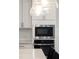 This kitchen features stainless steel appliances built into white cabinetry at 139 Pronghorn Deer Ct, Garner, NC 27529