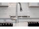 Kitchen with stainless steel faucet, white subway tile backsplash and black bar stool seating at 139 Pronghorn Deer Ct, Garner, NC 27529