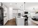 Well-lit kitchen connected to living area featuring a large island, stainless steel appliances, and hardwood floors at 139 Pronghorn Deer Ct, Garner, NC 27529