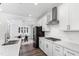 Bright kitchen with white cabinets, stainless steel appliances, and hardwood floors at 139 Pronghorn Deer Ct, Garner, NC 27529