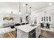 Open concept kitchen featuring a large island with bar seating and views of the dining and living areas at 139 Pronghorn Deer Ct, Garner, NC 27529