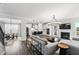 Bright open-concept living space with modern lighting, fireplace, and adjacent dining area with hardwood floors at 139 Pronghorn Deer Ct, Garner, NC 27529
