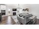 Bright open-concept living space with hardwood floors, fireplace, and open layout to kitchen and dining at 139 Pronghorn Deer Ct, Garner, NC 27529